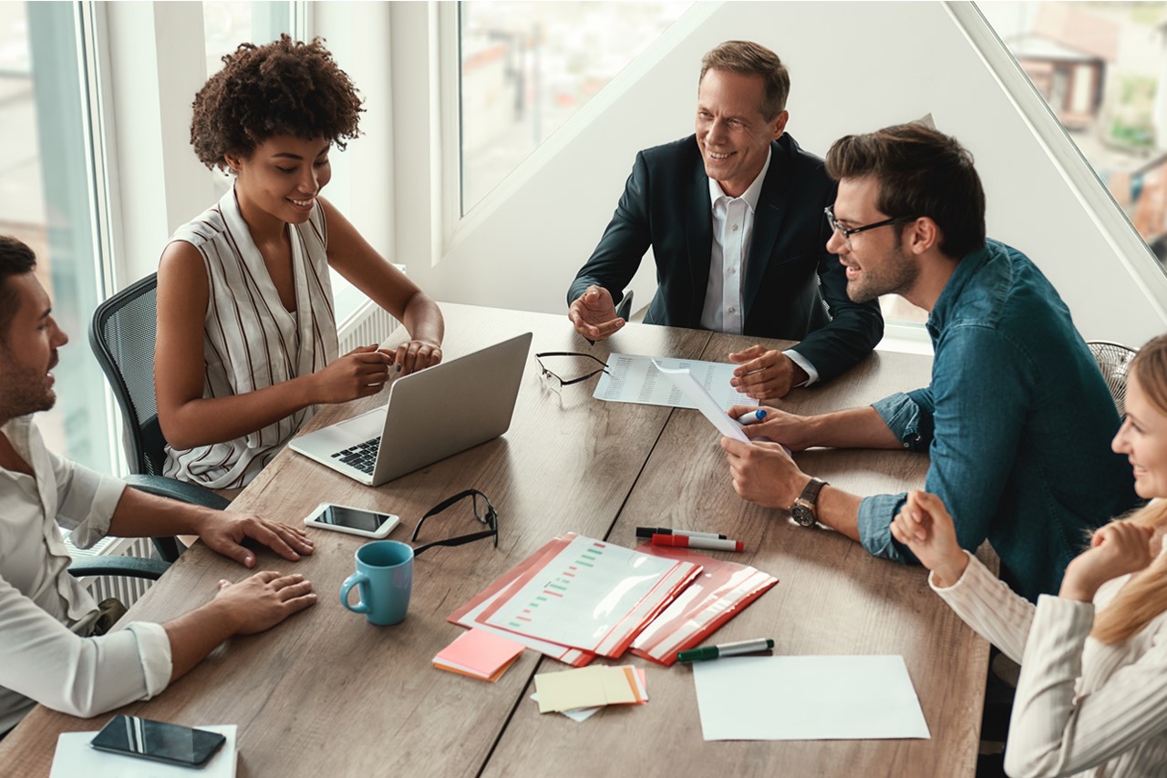 Team of professionals collaborating in modern office – talent strategy planning session