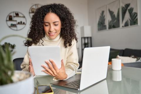 A lady looking at the laptop to see how to Use AI to Get More Interviews and Better Offers?