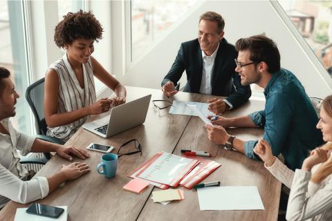 Team of professionals collaborating in modern office – talent strategy planning session